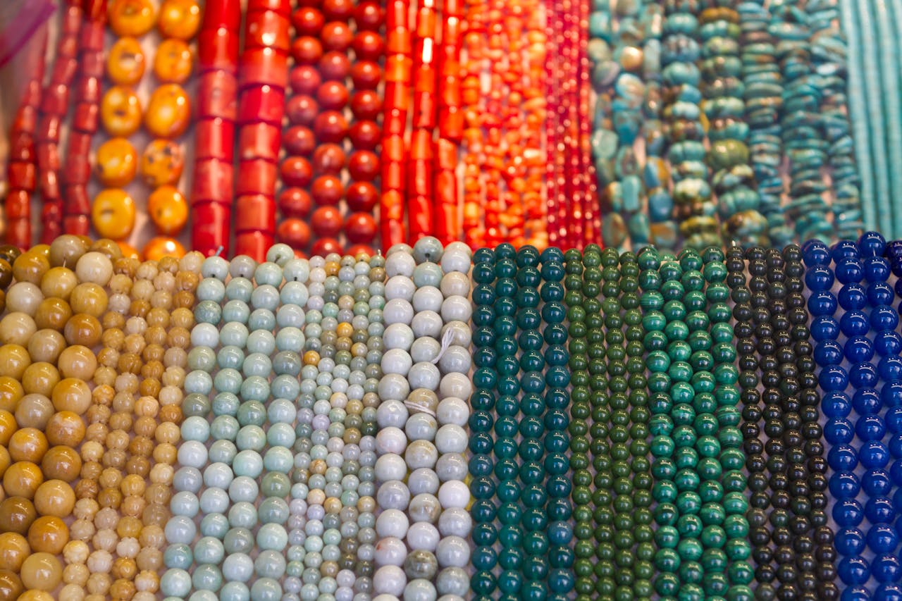 Vibrant and diverse collection of gemstone bead strands in various colors and sizes on display.